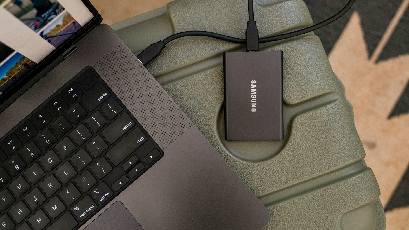 Portable external drive connected to a laptop showing a folder of photos