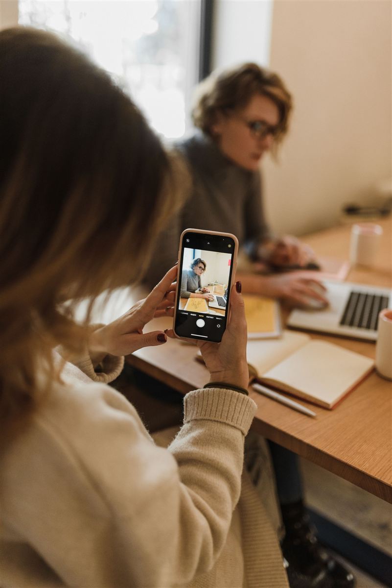Person snapping a photo of a friend